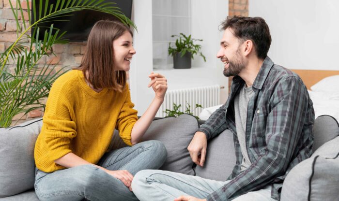 medium-shot-couple-laughing-couch (1) medium-shot-couple-laughing-couch (1)