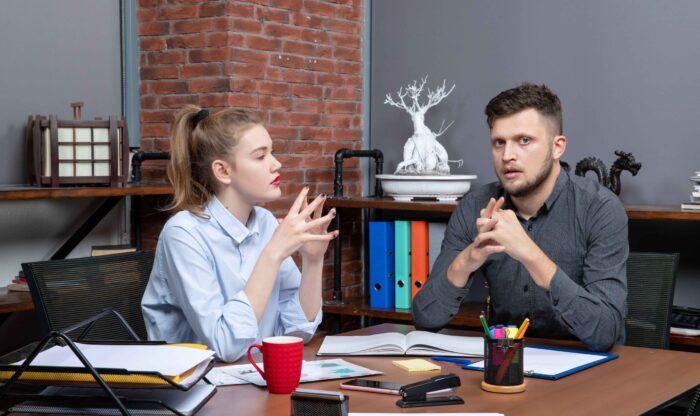 top-view-young-female-worker-her-male-co-worker-sitting-table-discussing-one-important-issue-office-enviroment (1) top-view-young-female-worker-her-male-co-worker-sitting-table-discussing-one-important-issue-office-enviroment (1)